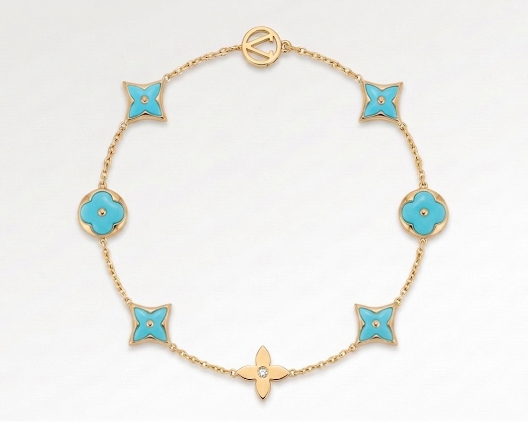 Gold bracelet with turquoise flower-shaped charms on a white background