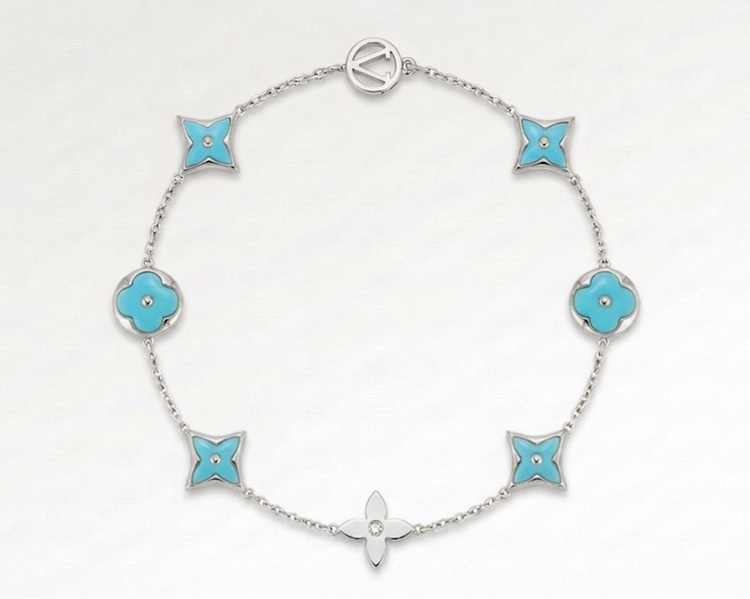 Silver bracelet with turquoise flower-shaped links on a white background