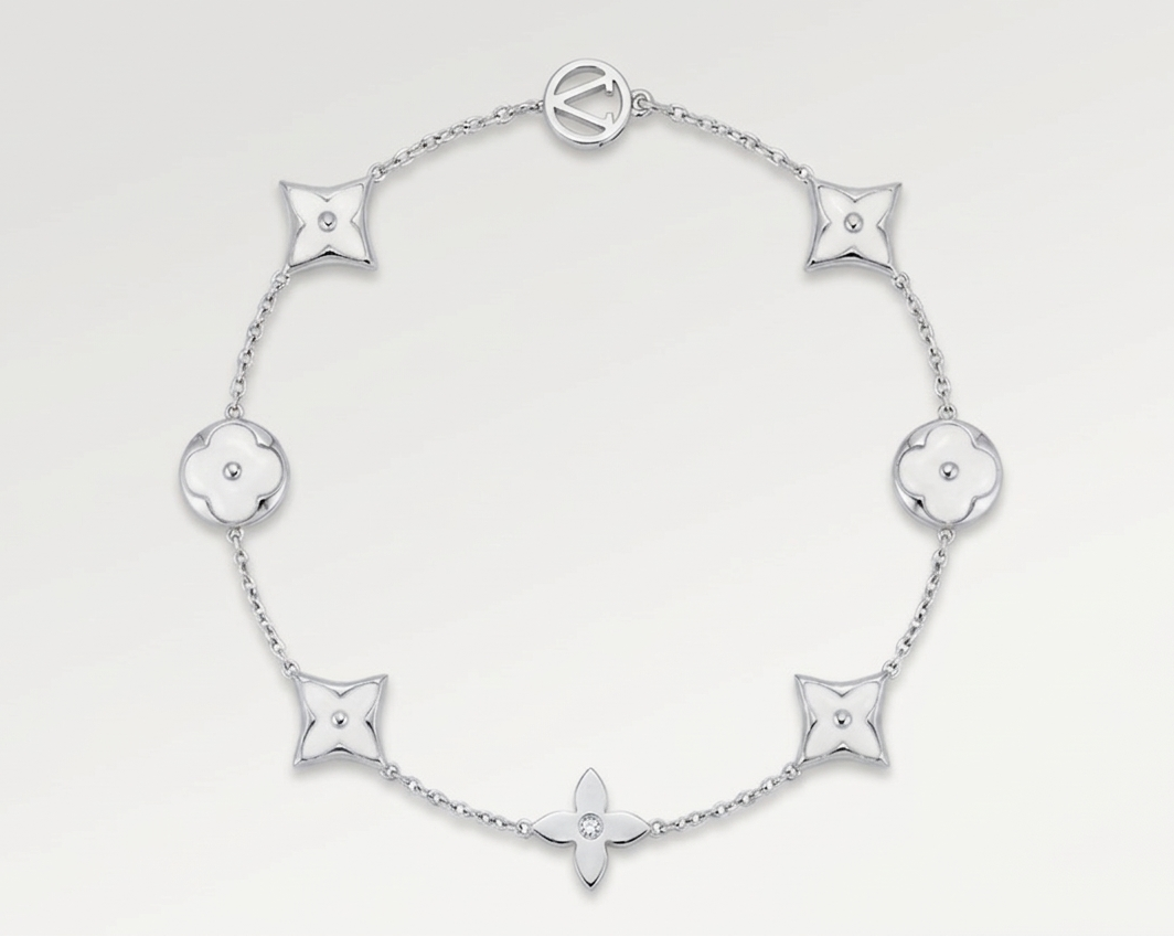Silver bracelet with white flower-shaped links on a white background