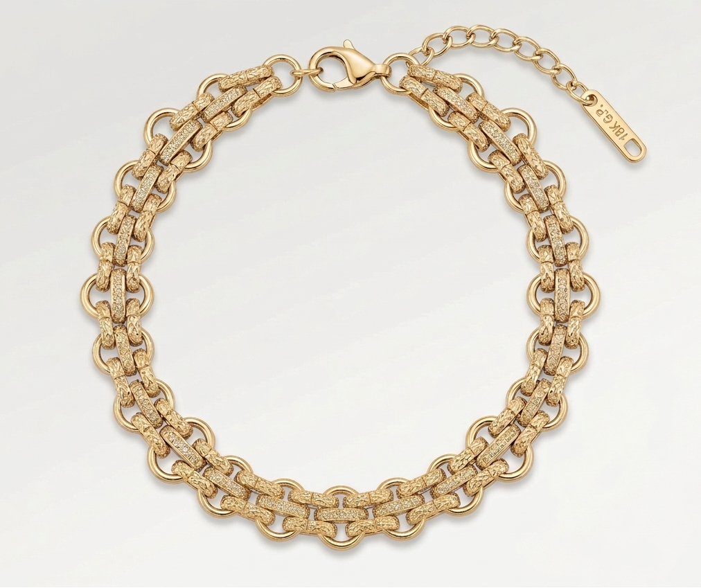 Gold chain bracelet on a light gray background
